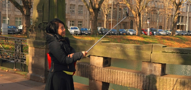 woman-taking-selfie-with_-selfie-stick