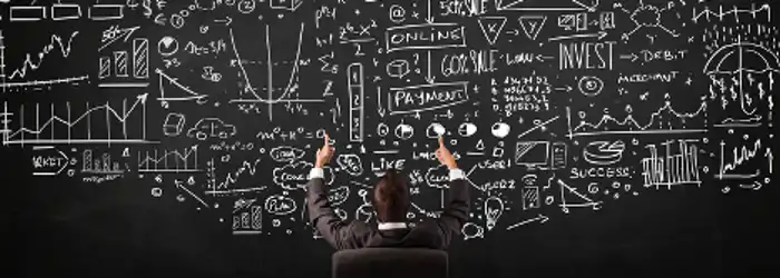 businessman-sitting-in-front-of-blackboard