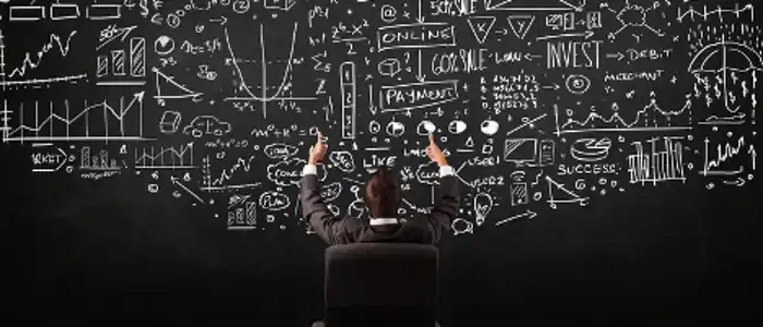 businessman-sitting-in-front-of-blackboard